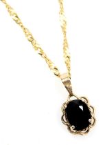 A 9ct gold and sapphire single stone pendant, on a fine curb link neck chain, with bolt ring clasp,