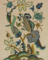 An early 20thC woolwork picture, decorated in the Elizabethan style with a squirrel before a stylise