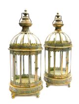 A pair of metal and glass lanterns, with a verdigris finish, having an urn finial, shell embossed an
