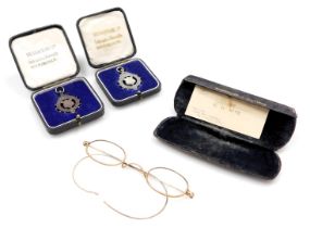A pair of early 20thC spectacles, yellow metal, stamped 10ct, and two Metropolitan Academy of Music