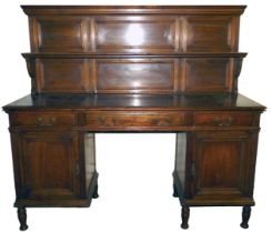 A late Victorian oak panelled back sideboard, with a plate rack, over a base with one long and two s