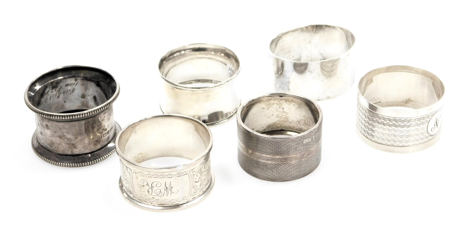 Six silver napkin rings, variously decorated, 3.39oz.