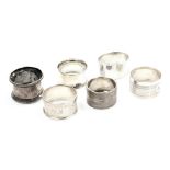 Six silver napkin rings, variously decorated, 3.39oz.