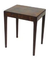 A mid century Herbert Gibbs rosewood side table, of rectangular form, raised on turned tapering legs