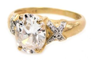 A 9ct gold and cz dress ring, with a central oval cut stone in a claw setting, with cz set shoulders