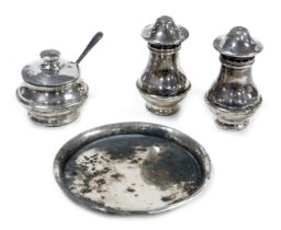 An Elizabeth II silver three piece condiment set, on tray, comprising pepperette, salt and mustard p