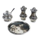 An Elizabeth II silver three piece condiment set, on tray, comprising pepperette, salt and mustard p