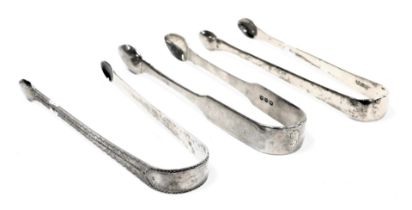 Three pairs of George III silver sugar tongs, one with bright cut engraving, another initial engrave