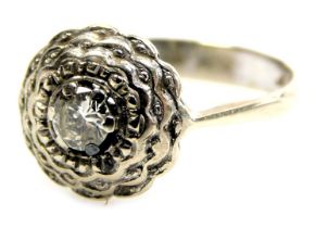 A diamond solitaire ring, in a stepped, circular mount, white metal, stamped 750, approximately 0.4c