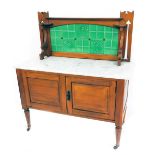 A Victorian satin walnut washstand, with a tiled splashback and white metal top over a pair of panel