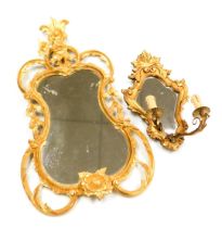 A Rococo style parcel-gilt wall mirror, moulded with fruit, flowers, acorns and scrolling leaves, 70