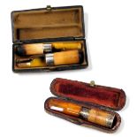 A meerschaum cigar holder, and a cheroot holder, with silver banding and amber tips, cased, and a fu