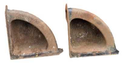 A pair of early 20thC cast iron corner horse feeder troughs, 31cm high, 68cm wide, 68cm deep.