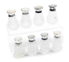 A set of four George V cut glass salts, with silver and mother of pearl screw lids, Birmingham 1928