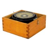 A mid-century ship's gimbal compass, oak cased, compass 13cm wide.