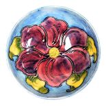 A Moorcroft pottery Clematis pattern bowl, turquoise ground, impressed marks, 14cm wide.