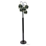 A black metal standard lamp, with tiered floral brass and grey glass shades, 167cm high.