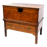 A George III oak blanket chest, with a cast iron plate, raised above a long drawer, on square legs,