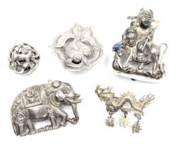 Two 20thC Chinese white metal lapel badges, formed as a Shubunkin, and a dog of fo, a dragon brooch,