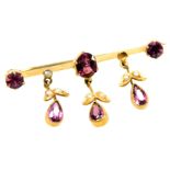 An Edwardian amethyst and seed pearl trembleuse floral bar brooch, yellow metal, 2.8g (AF)