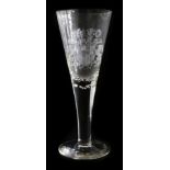 A German glass presentation goblet, of fluted form, engraved with a coat of arms, raised on a conica