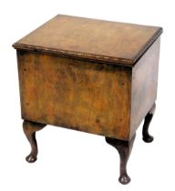 An early 20thC oak sewing box, with a hinged lid, and a padded interior, raised on cabriole legs, 53