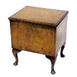 An early 20thC oak sewing box, with a hinged lid, and a padded interior, raised on cabriole legs, 53