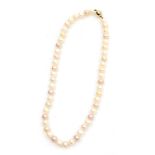 A string of uniform cultured pearls with a white or pink hue, on a ball clasp stamped 9ct.