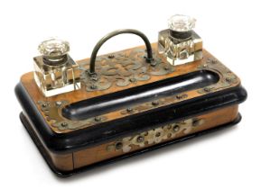 A Victorian walnut and ebonised desk stand, with brass mounts and cut glass inkwells, with a frieze