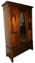 An Edwardian mahogany and inlaid double wardrobe, with a central mirrored door with inset bevelled g