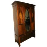 An Edwardian mahogany and inlaid double wardrobe, with a central mirrored door with inset bevelled g