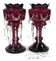 A pair of late 19thC ruby glass lustres, with enamel decoration of floral swags, with prismatic clea