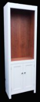 A grey painted sapele wood kitchen cupboard, with a vacant space containing racking for shelves, abo