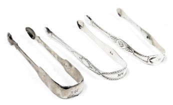 Two pairs of George III silver sugar tongs, with engraved decoration, together with a pair of George