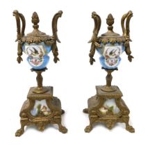 A pair of late 19thC porcelain and brass garniture urns, decorated with reserves of birds and flower