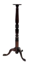 A Victorian mahogany torchère stand, the circular top on a fluted and turned column, above three cab