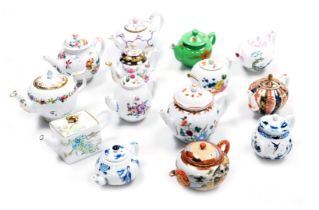 A group of Victoria & Albert Collection porcelain teapots, by Franklin Mint, and a Kutani teapot. (a