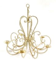 A cream painted cast iron five branch chandelier, with a distressed finish, 60cm high.