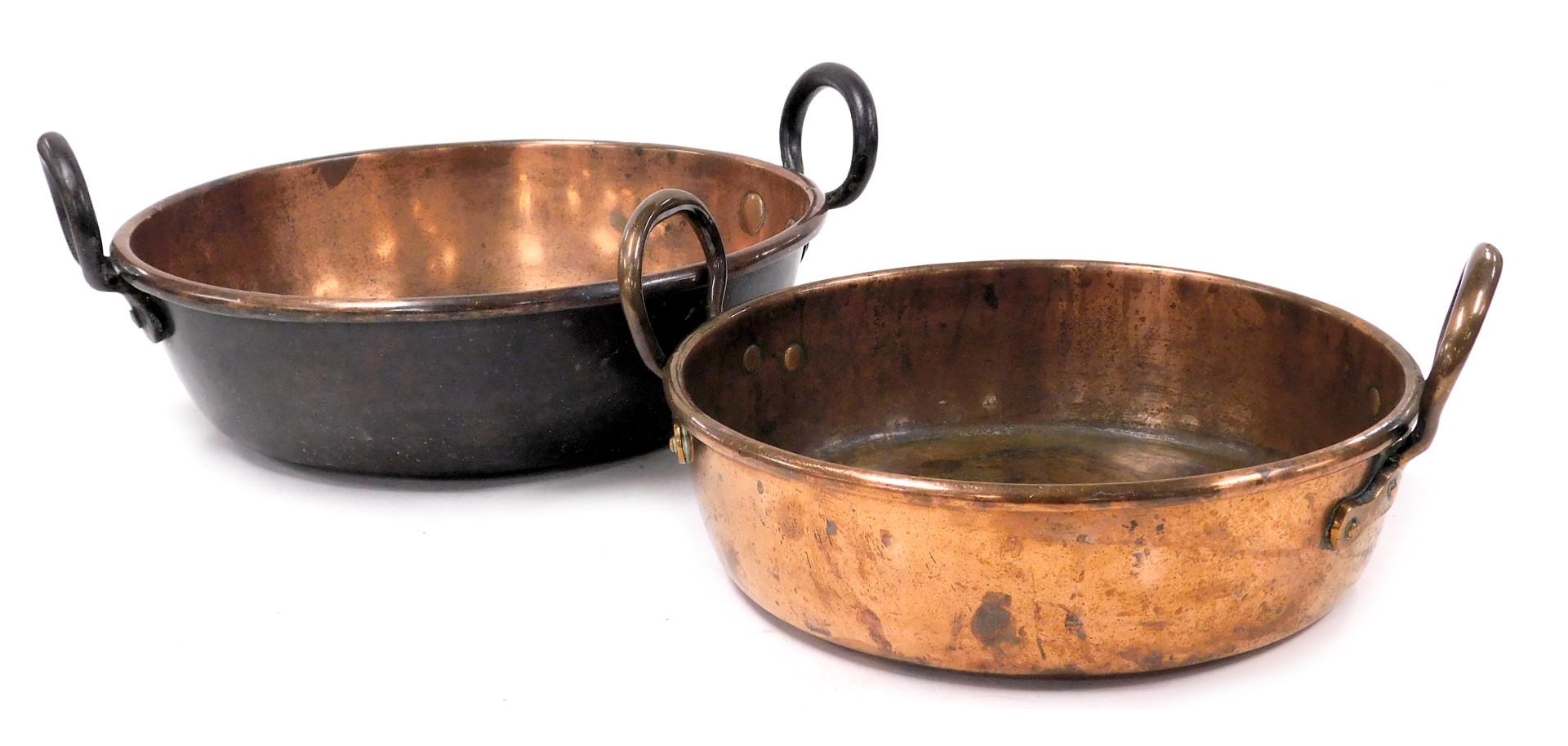 Two graduated copper twin handled jam pans, 41cm and 35cm wide.