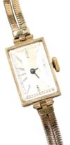 A mid century 9ct gold cased lady's wristwatch, rectangular silvered dial bearing Arabic numerals, p