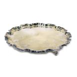 Elizabeth II silver pie crust salver, raised on three scroll feet, the underside presentation engrav