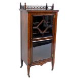 A Victorian rosewood music cabinet, with a fretwork gallery, over a glazed door enclosing three shel
