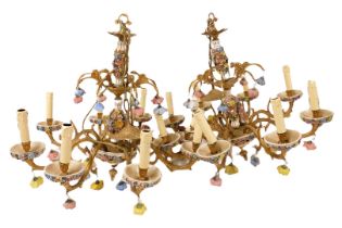 A pair of mid century brass and porcelain eight branch chandeliers, the stems encrusted with flowers