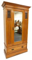 A Victorian satin walnut wardrobe, the outswept pediment over a central door inset bevelled glass, f