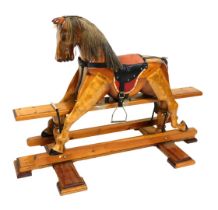 A pine rocking horse, 134cm wide.