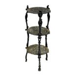 A Victorian black cast iron three tier stand, raised on three cabriole supports, 66.5cm high.