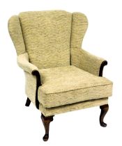 A Parker Knoll mahogany wing back arm chair, upholstered in wavy button back oatmeal fabric, raised