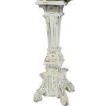 A cream painted torchère stand, the square top above a tapering and foliate carved column, over four