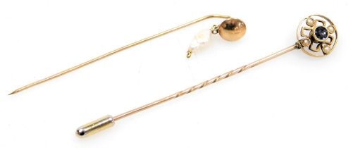 An Edwardian sapphire and seed pearl tie pin, in a circular openwork design, in yellow metal, stampe