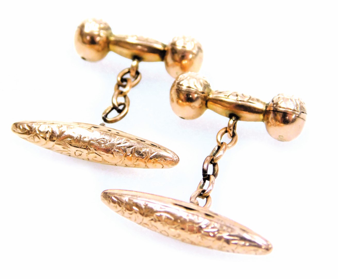A pair of 9ct rose gold cufflinks, of torpedo, barbell and chain link form, with floral engraving, 3